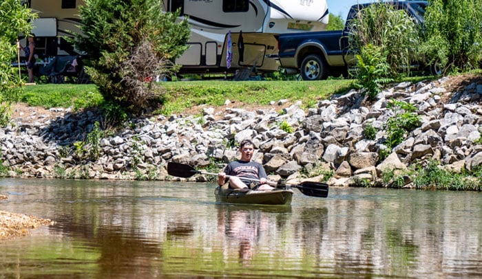 man kayaking in piney river rv resort