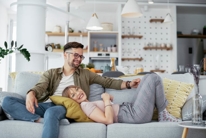 happy couple relaxing in a small tiny home living room