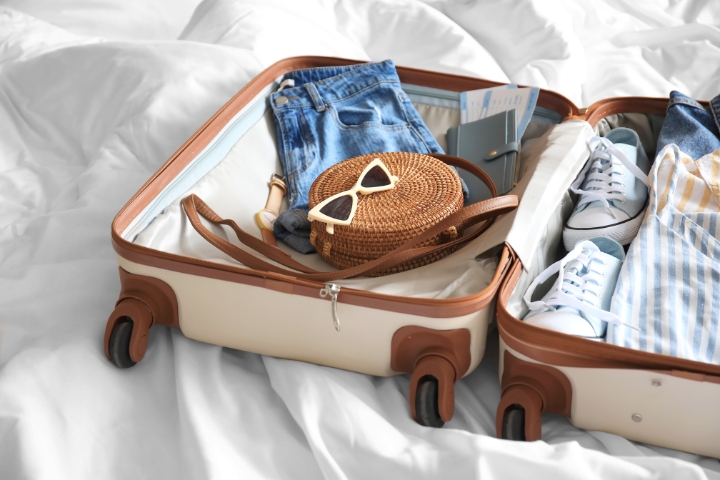 open packed suitcase on bed