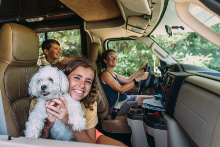 happy family with a dog inside an rv