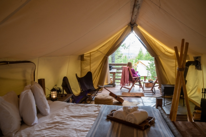 woman sitting outside glamping tent