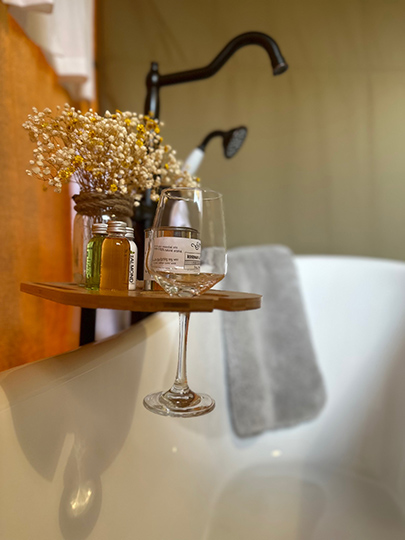 bath tub and wine glass inside a glamping tent