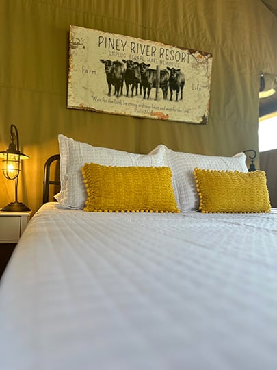 https://pineyriverresort.com/wp-content/uploads/2023/08/glamping-tent-bed.jpg