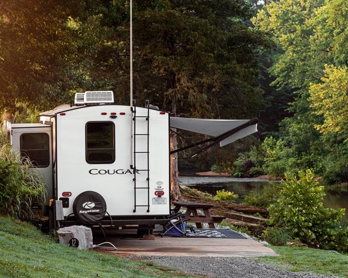 white rv parked near piney river