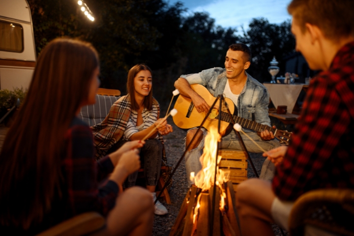 young people bonding over campfire