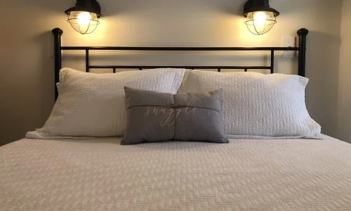 Tiny Home Stays 184 The Lighthouse tiny home bed and pillows