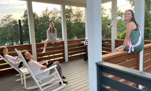Tiny Home Stays 205 group of people on a tiny house porch