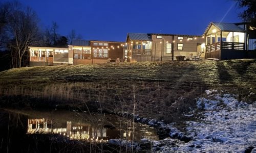 Tiny Home Stays 203 Night time view of the pond outside the tiny homes at Piney River Resort